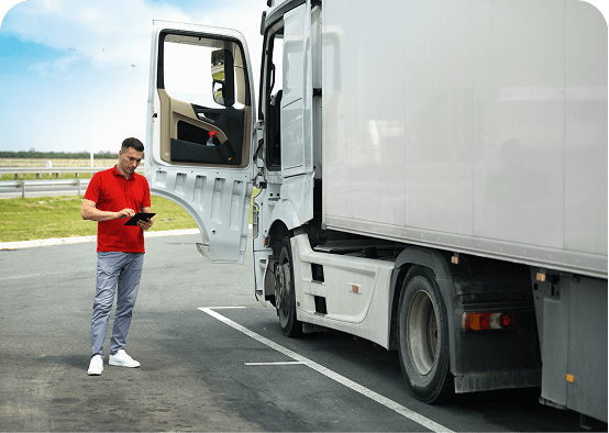 Man in red shirt beside open truck door