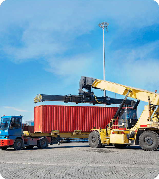 Forklift moving red shipping container